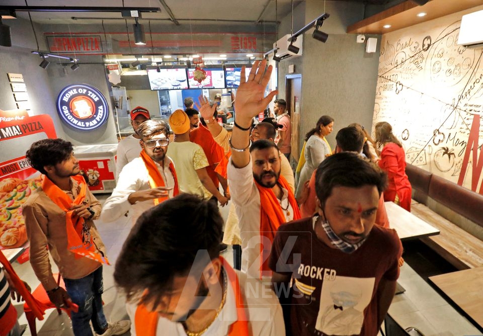 Activists of Bajrang Dal, a Hindu hardline group, shout slogans inside a Pizza Hut food outlet during a protest over their Pakistani partners' tweet in support of Kashmir, in Ahmedabad, India, February 12, 2022. REUTERS/Amit Dave